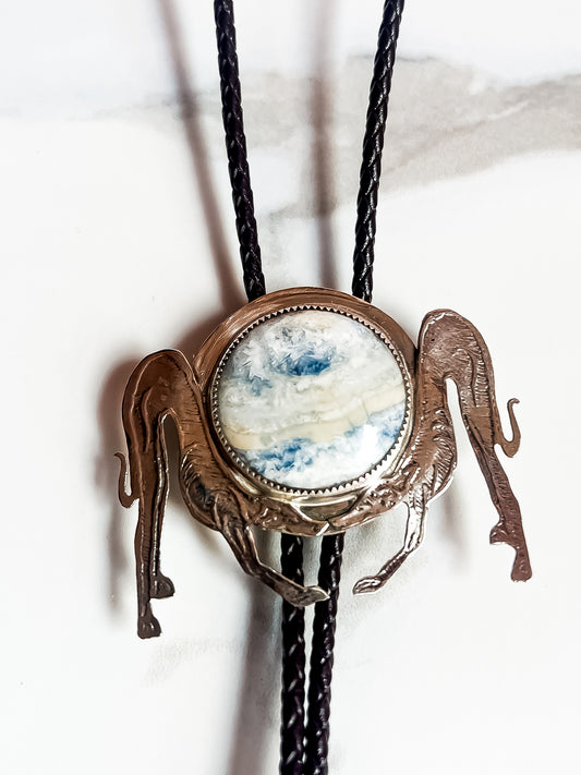 Etched Silver Bowing Dog Bolo Tie with Blue Sheelite